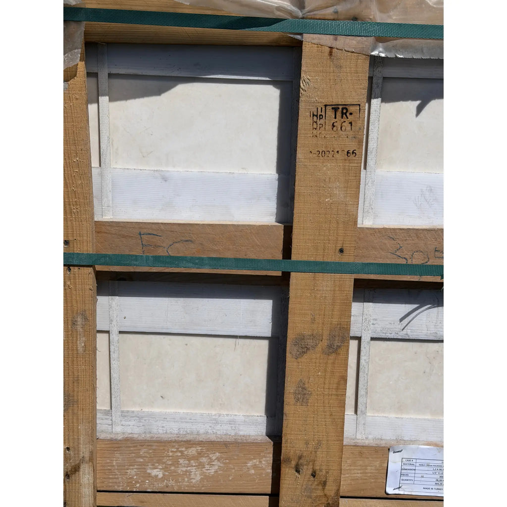 Wooden pallet with green straps securing white pearl botticino beige marble 12x12 polished or honed panels