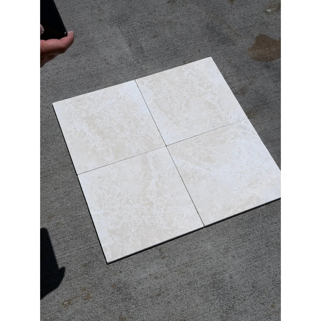 Four square beige marble effect tiles arranged in a grid white pearl botticino beige marble 12x12 tumbled