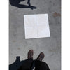 Four off-white white pearl botticino beige marble ceramic tiles arranged in a 2x2 grid with tumbled finish