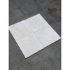 Four white pearl botticino beige marble 12x12 tumbled ceramic tiles with subtle marbled texture on dark gray surface