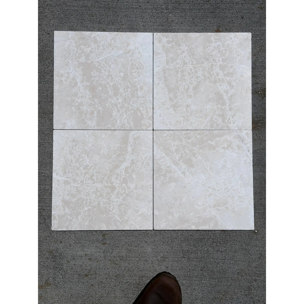 Four square light gray white pearl botticino beige marble 12x12 tumbled tiles arranged in a grid