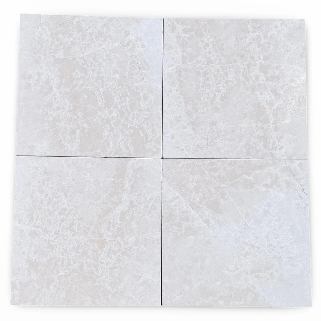 Four square light gray white pearl botticino beige marble tiles with subtle veining arranged in a 12x12 grid