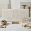 A rectangular slab of polished white pearl botticino beige marble with subtle veining in 12x24 size