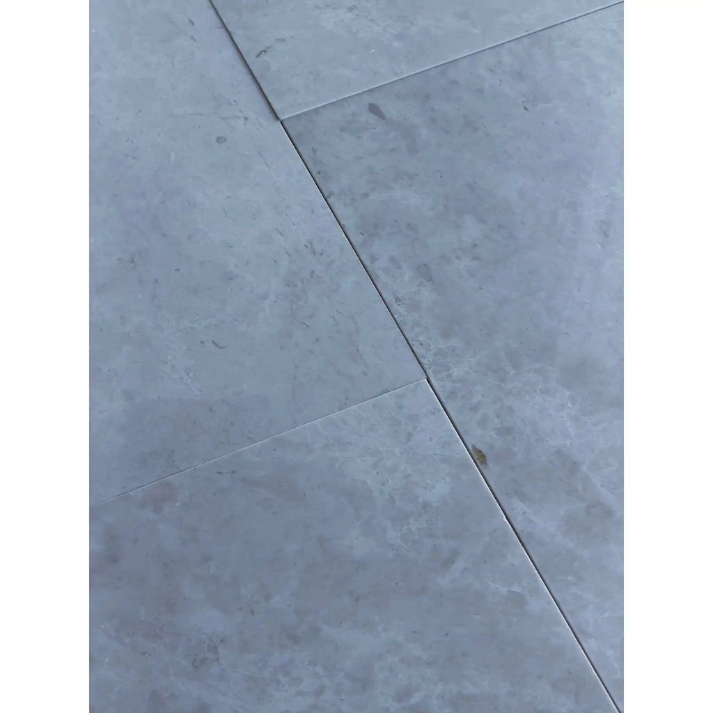 Light gray White Pearl marble 12x24 floor tiles with subtle veining