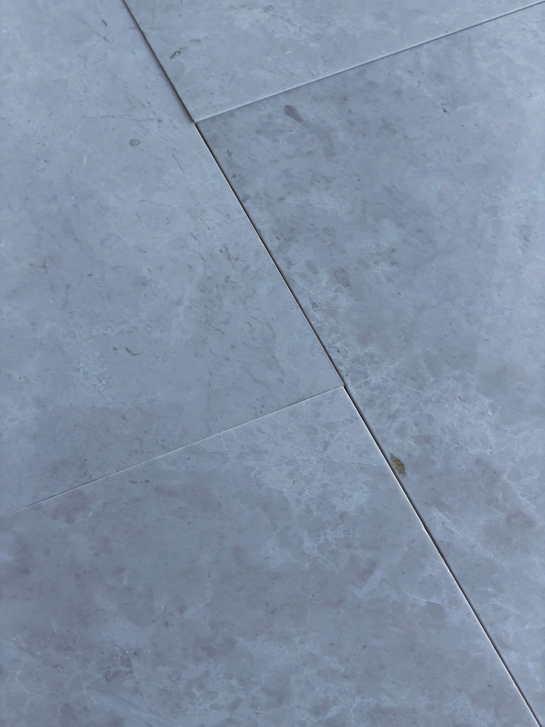 Light gray White Pearl marble 12x24 floor tiles with subtle veining