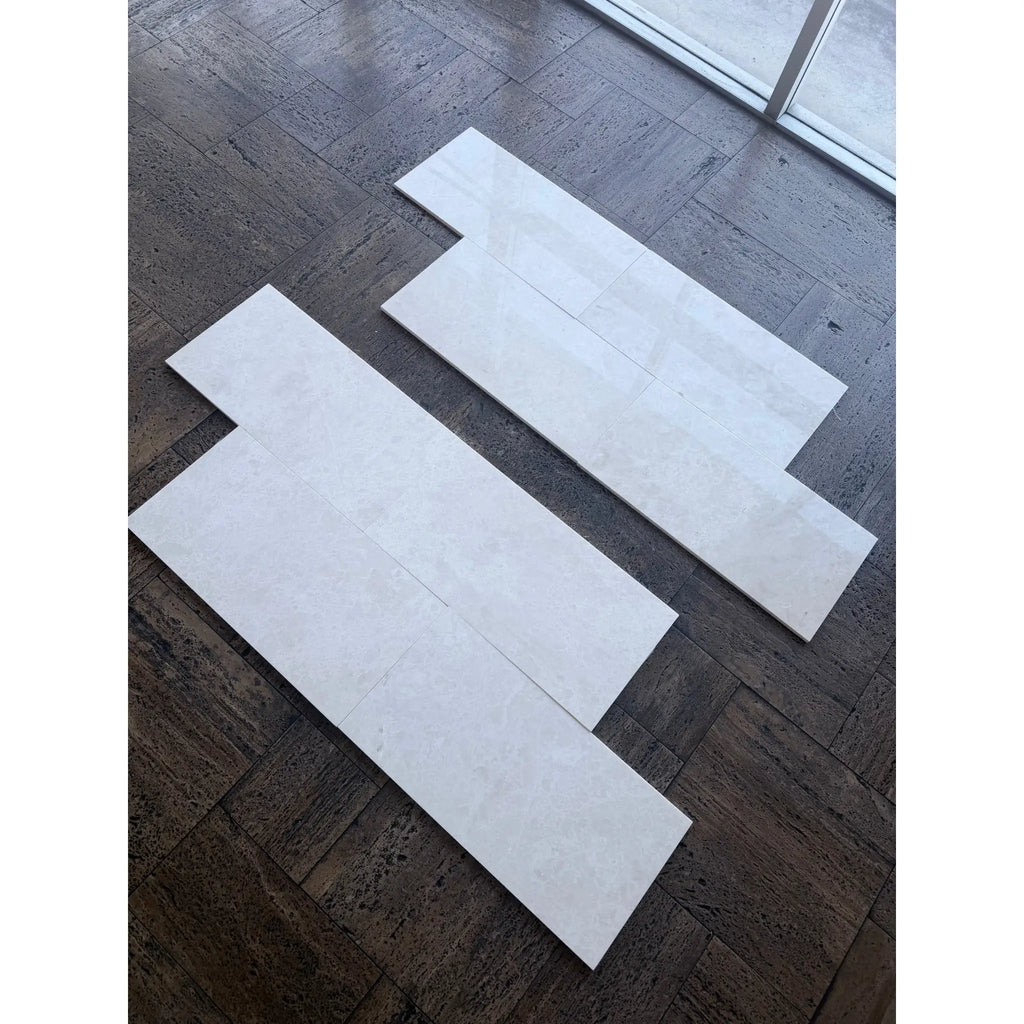 White Pearl Botticino Beige marble 12x24 polished tiles with subtle veining on dark floor
