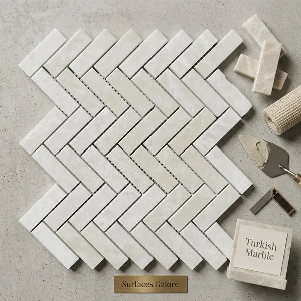 White pearl botticino beige marble tiles polished in a 1x3 herringbone mosaic pattern showcasing turkish marble