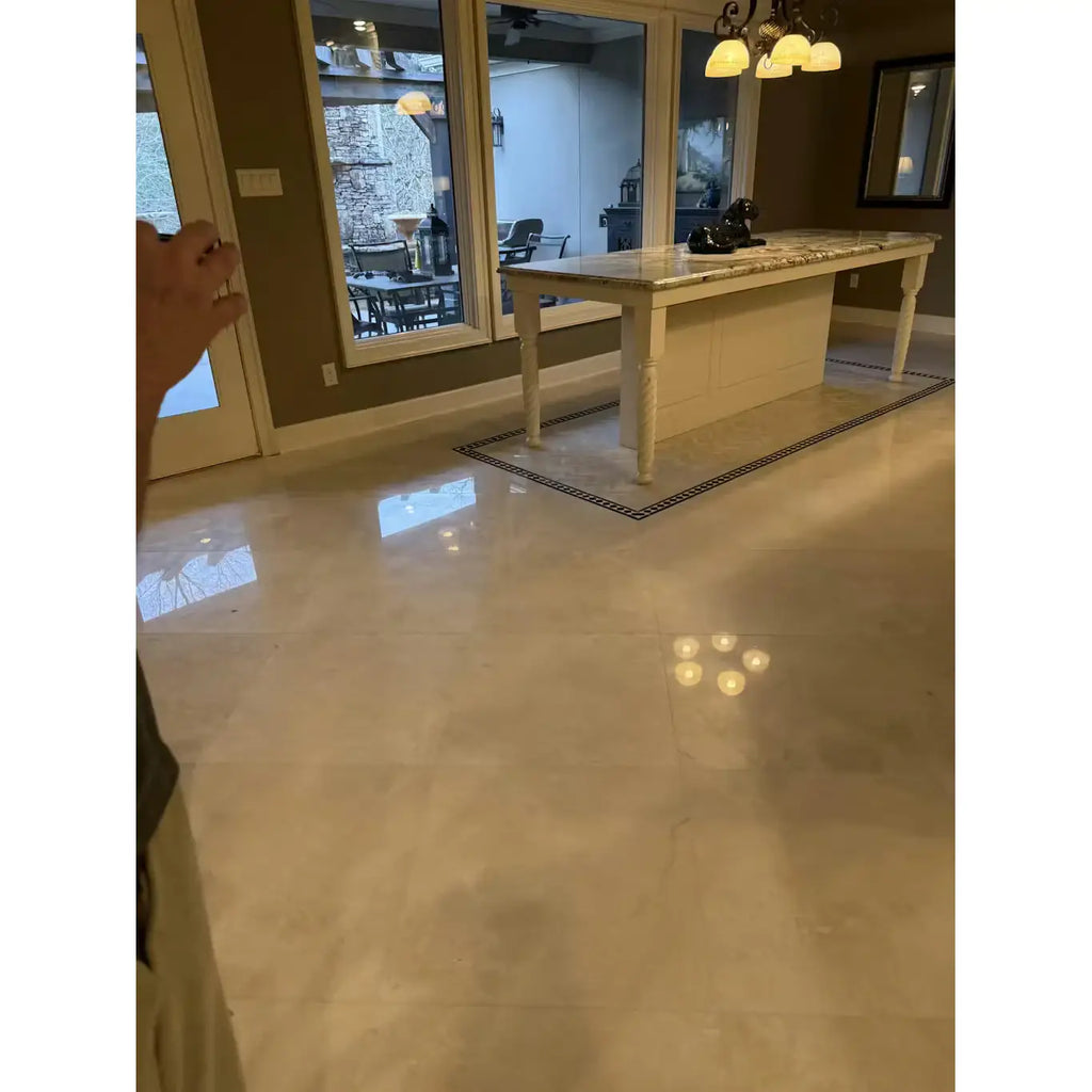 Cream-colored White Pearl Botticino Beige marble kitchen island with light beige countertop and white legs