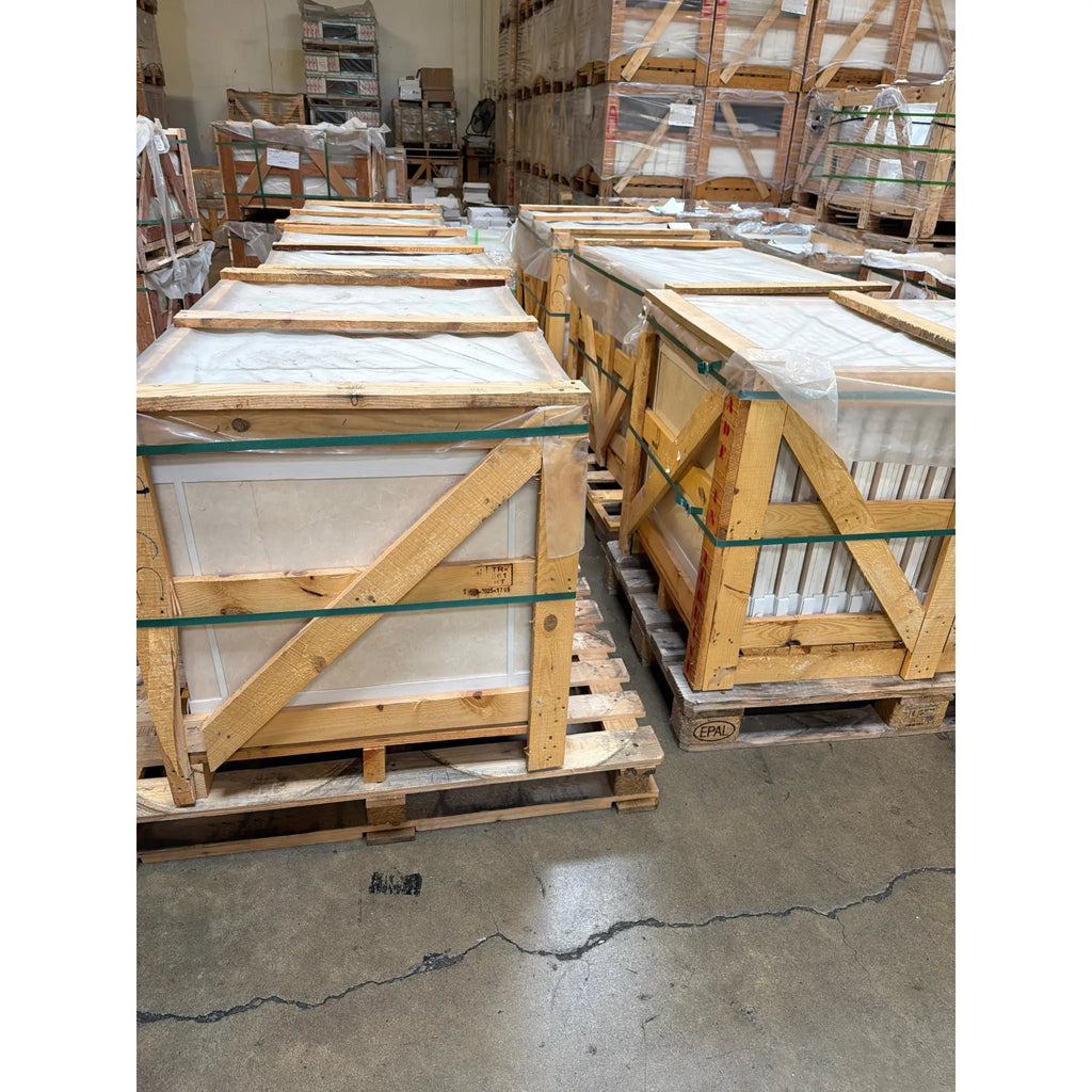 Stacked White Pearl Botticino Beige Marble crates in warehouse