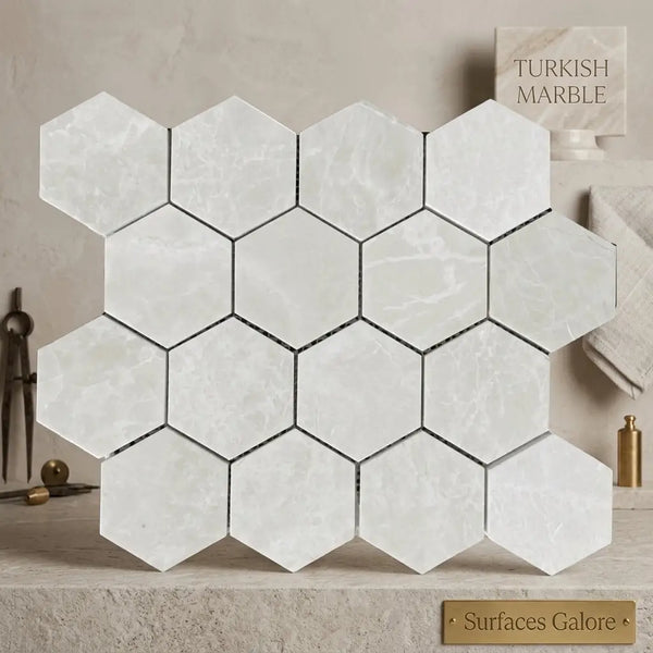 White pearl Botticino beige marble 3 inch hexagon mosaic tiles with subtle veining and black grout lines