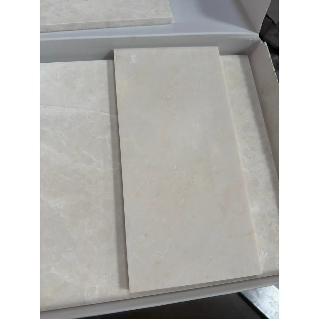 Beige marble-effect rectangular tiles with subtle veining and a smooth glossy finish in white pearl botticino beige marble 6x12 polished or honed