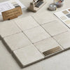 White pearl botticino beige marble 6x6 tumbled light beige turkish tiles with subtle veining in a grid pattern